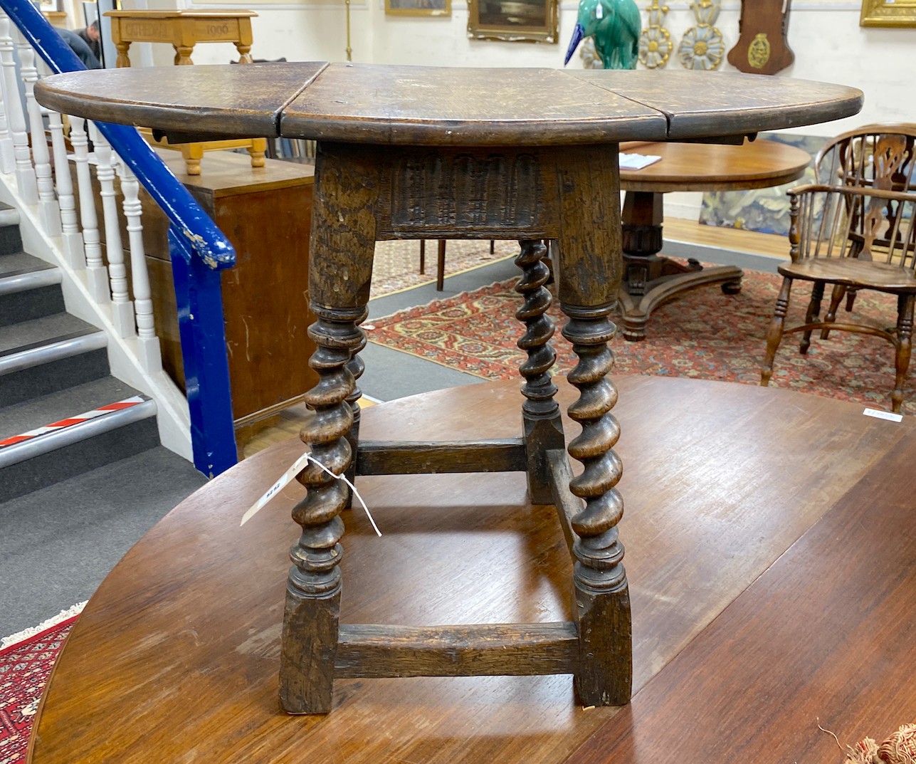 A Carolean style oak drop flap occasional table on spiral turned under frame width 69cm extended, depth 50cm, height 51cm